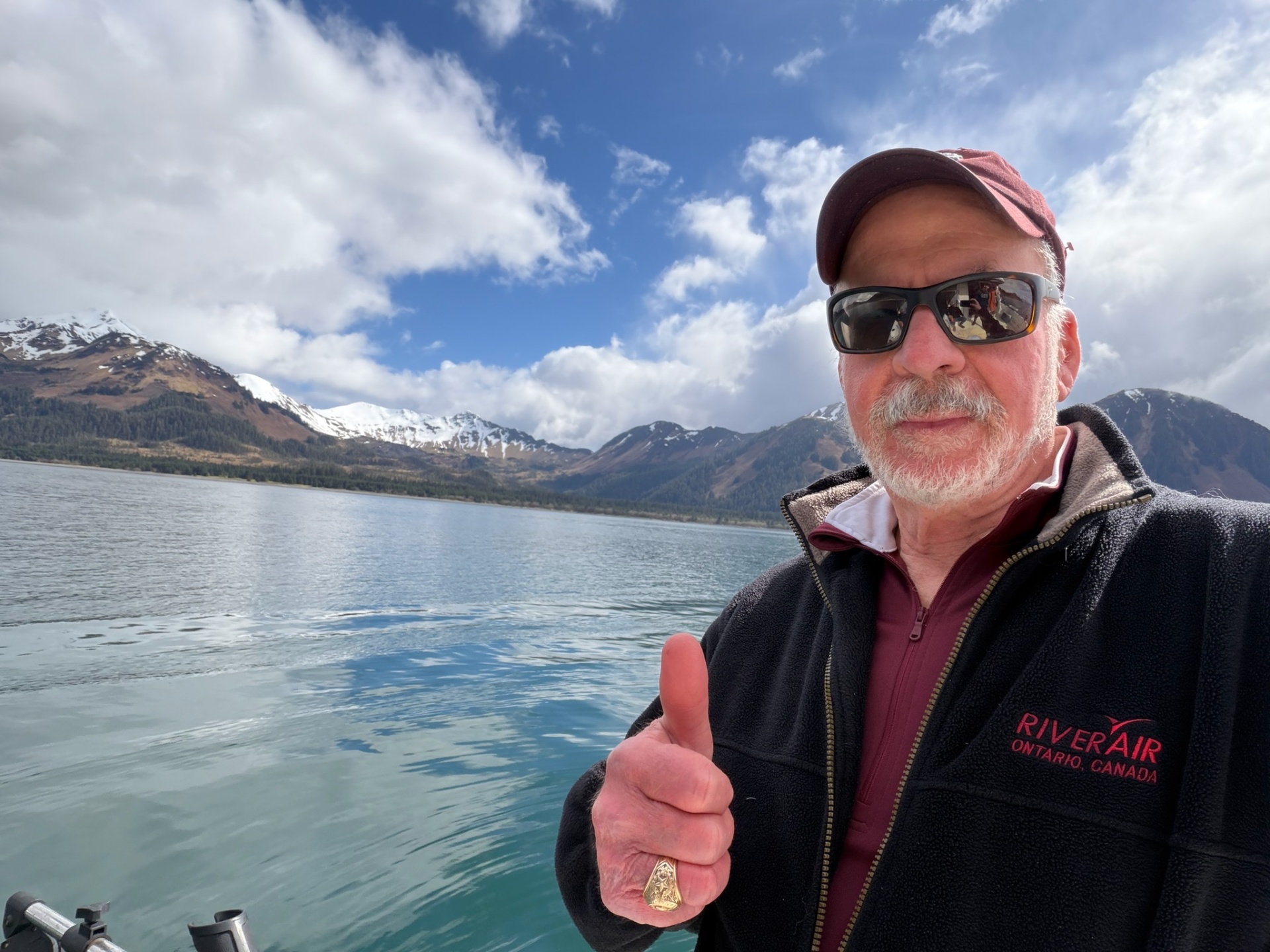 Lee on a lake with snow-capped mountains